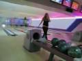 Girl throws bowling ball