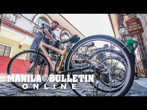 Foreign tourists rent bikes in Intramuros, Manila