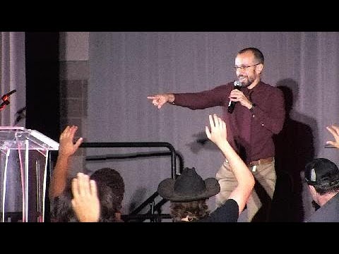 Mike speaking at a large venue
