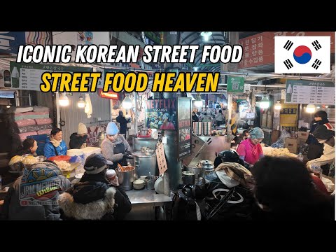 Gwangjang Market in Seoul with vendors preparing traditional Korean food including bindaetteok and kimbap
