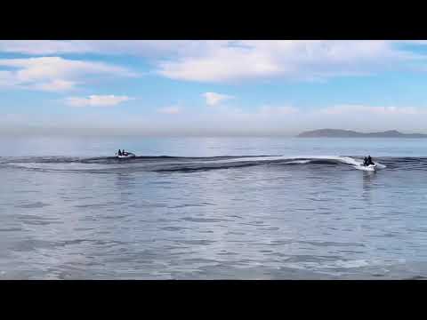 Aerial footage of surfers at Baja Malibu 