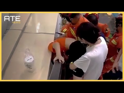 Firefighters in China rescue a boy who was wedged between an escalator and a wall