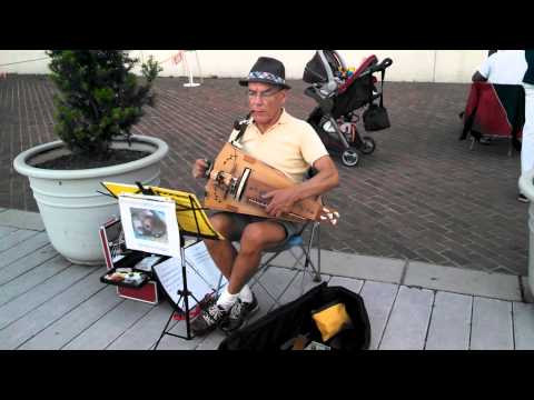 A man playing a hurdy gurdy in Old Town Alexandria, VA