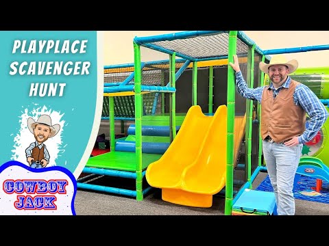 Thumbnail for a video: man in cowboy hat beside a bright indoor playground with yellow double slides and green climbing structures; text reads 'Playplace Scavenger Hunt' and 'Cowboy Jack'