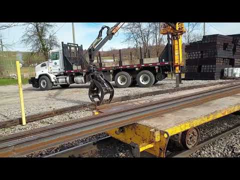 Loading 78 Foot Sticks of Rail on Rail Carts