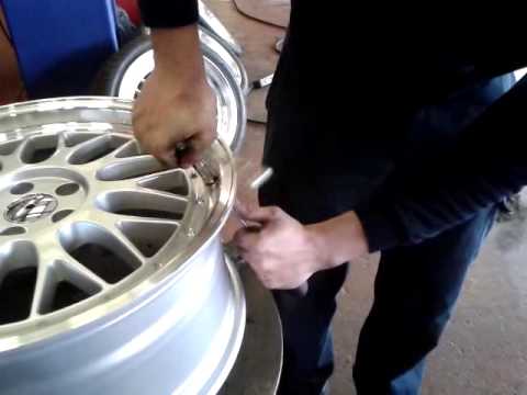 fitting metal wheel valve into bbs rim.
