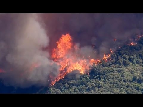 Giant wildfires grow in California during heat wave