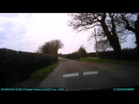 Vehicle speeding on a UK country lane and hump back bridge