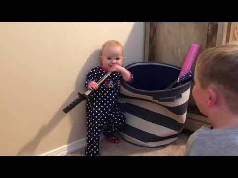 190903. Daisy plays with a ninja sword