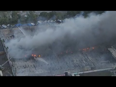 Over 200 firefighters battle massive warehouse fire in Miami-Dade that could burn for days, official