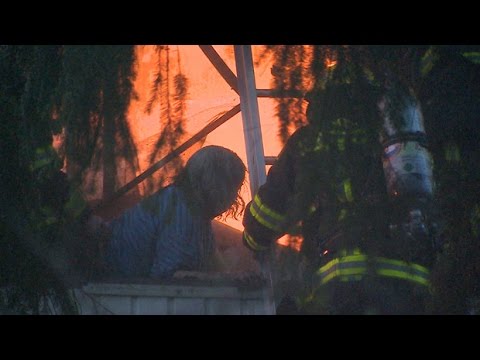 RAW: Dramatic rescue of woman surrounded by flames