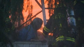 RAW: Dramatic rescue of woman surrounded by flames