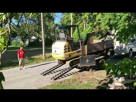 Unloading hoe from dump trailer