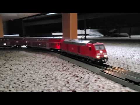 DB 245 009 coming around the bend with a freight train.