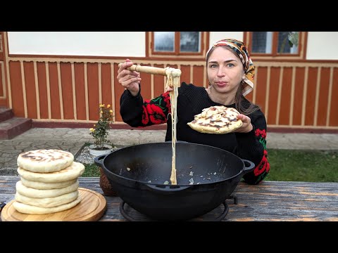 Village Cooking. Woman is frying wonderful traditional bread with cheese dish from mountain farm
