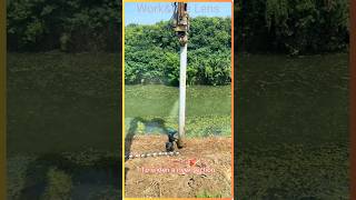Pile driving concrete piles into a river bank #construction