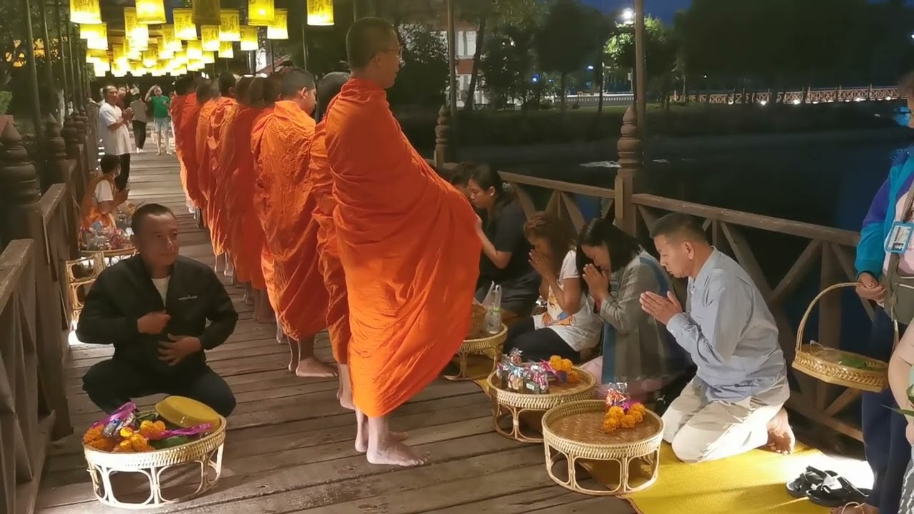 Experience the serene ritual of Almsgiving at dawn.