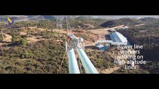 Power line workers walking on high altitude lines
