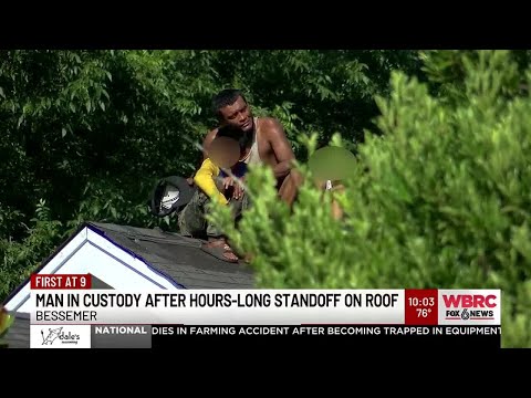Man in custody after hours-long standoff on roof