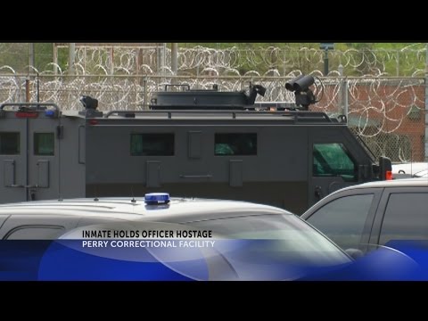 Inmate holds officer hostage