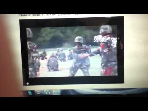 chinese soldiers pass live grenade