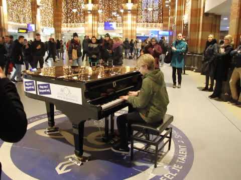 Amsterdam Centraal: A boy plays the piano at the train station on New Year's Eve 2019