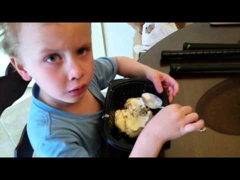 Paxton and Pryson having a bowl of vanilla ice cream with rainbow sprinkles.