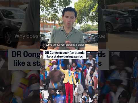 DR Congo soccer fan stands like a statue during games