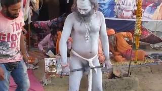 A Naga Sadhu displaying his yogic abilities