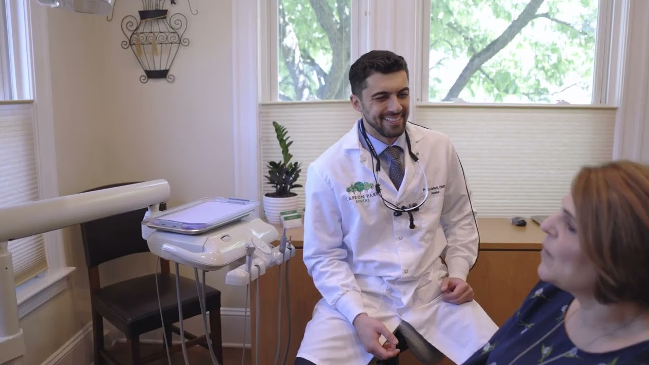 Attleboro dentist laughing with patient during dental visit