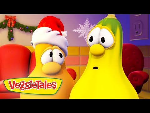 Two VeggieTales characters, one wearing a Santa hat, look surprised in a festive room with holiday decorations and the VeggieTales logo in the corner.