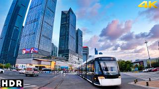 With Walk East . . . HeXi CBD visitor guide - NanJing Overview The Hexi Central Business District (Hexi CBD) is a modern and dynamic area located in the JianYe District of NanJing, China. Known for its impressive skyscrapers, luxury shopping malls, and vibrant business environment, Hexi CBD is a major commercial hub and a popular destination for both business and leisure visitors. Getting There Location: JianYe District, NanJing, JiangSu Province, China. Public Transport: By Metro: Take Metro Line 1 or Line 2 and get off at Yuantong Station, which is centrally located in Hexi CBD. By Bus: Numerous bus lines serve the Hexi CBD area. Key stops include the Yuantong Station and NanJing International Expo Center. By Taxi: Taxis are readily available throughout NanJing and can take you directly to Hexi CBD. Main Attractions Hexi CBD offers a variety of attractions and points of interest: NanJing International Expo Center: A major venue for exhibitions, conferences, and events, attracting visitors from around the world. JianYe Wanda Plaza: A large shopping complex offering a mix of high-end retail stores, dining options, and entertainment facilities. Eco-Tech Island: A scenic area with green spaces, walking paths, and eco-friendly initiatives, perfect for a leisurely stroll or relaxation. NanJing Olympic Sports Center: A state-of-the-art sports complex hosting various sports events and concerts. Hexi Central Park: A beautiful park offering a tranquil environment with gardens, lakes, and recreational facilities. Shopping and Dining Hexi CBD is a paradise for shopping and dining enthusiasts: Luxury Shopping: High-end shopping malls like Deji Plaza and JiMao Shopping Mall offer luxury brands and designer boutiques. Local Cuisine: Experience authentic JiangSu cuisine at renowned restaurants and local eateries. International Dining: The area features a wide range of international restaurants offering diverse cuisines from around the world. Cafes and Bars: Numerous cafes and bars provide a perfect spot to relax, enjoy a drink, and socialize. Business and Accommodation Hexi CBD is a key business district with excellent facilities and accommodation options: Business Centers: Modern office buildings and business centers host numerous multinational companies and enterprises. Hotels: Luxury hotels such as the Jinling Riverside Hotel and Hilton NanJing offer top-notch accommodation and amenities for business travelers. Conference Facilities: State-of-the-art conference and meeting facilities are available for business events and meetings. Activities Visitors can engage in a variety of activities in Hexi CBD: Shopping: Explore the numerous shopping malls and boutique stores. Dining: Enjoy a meal at one of the many restaurants offering a wide range of cuisines. Relaxing in Parks: Spend time in the green spaces and parks for a peaceful retreat. Attending Events: Participate in exhibitions, conferences, and sports events held at the various venues. Exploring Nightlife: Experience the vibrant nightlife with bars, clubs, and entertainment options. Visitor Tips Best Time to Visit: Spring and autumn are the best times to visit due to the pleasant weather. Wear Comfortable Shoes: The area is large and involves a lot of walking, so comfortable shoes are recommended. Plan Ahead: Check the schedule for events and exhibitions to make the most of your visit. Stay Connected: Free Wi-Fi is available in most public areas and shopping malls. Respect Local Customs: Be mindful of local customs and etiquette, especially in business settings. Nearby Attractions FuZi Miao (Confucius Temple): A historic site offering cultural insights and traditional architecture, located a short distance from Hexi CBD. XuanWu Lake: A scenic lake surrounded by parks, ideal for boating and leisurely walks. NanJing Museum: One of China`s leading museums, showcasing extensive collections of historical and cultural artifacts. Conclusion The Hexi CBD in NanJing is a vibrant and modern district offering a mix of business, shopping, dining, and entertainment experiences. Whether you`re a business traveler, a shopper, or simply looking to explore a dynamic urban area, Hexi CBD provides an exciting and memorable experience. Riding the tram through NanJing's futuristic HeXi CBD