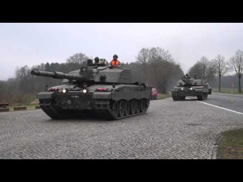 Challenger 2 main battle tanks driving by