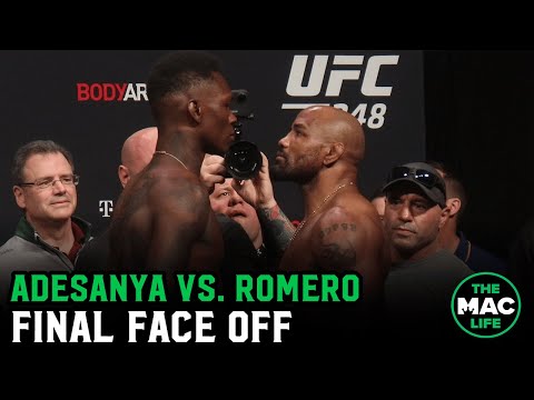 Israel Adesanya and Yoel Romero have intense final staredown as Adesanya smokes a Cuban cigar