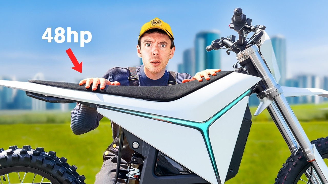 Logan Taylor riding the Y-Volt Surge V electric dirt bike on a trail, wearing overalls and a helmet