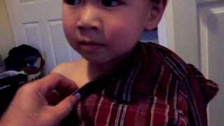 My boy trying to take off his shirt