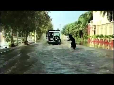 Surfing Saudi style: Woman wakeboards down flooded street