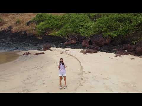 girl photographer on a wild beach makes photos, aerial photography
