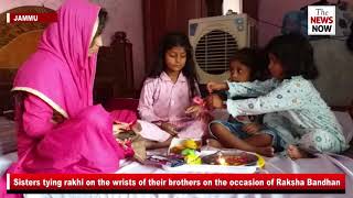 Sisters tying rakhi on the wrists of their brothers on the occasion of Raksha Bandhan
