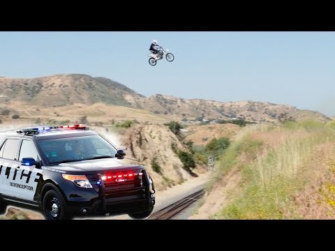 Motorcycle Escapes Police by Jumping over Train Tracks