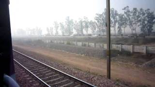 preview picture of video 'Hirakud Express: near New Delhi train racing along highway'