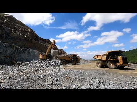 Excavator Loading Rocks On Dump Truck, Caterpillar Excavator 374F