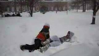 Snow Day in Muncie!  Girl gets tackled HARD, watch her feet!