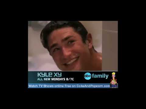 Kyle XY trailer frame: Kyle stands in a rain-lit Seattle street, the camera drifting as a piano motif begins