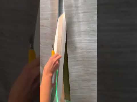 Double cutting guide on curved wall w grasscloth & cut tape