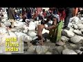 Mother Bathing Kid In Freezing Water Of River Ganga At Gangotri