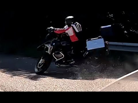 Crash on a motorcycle tour in Sardinia. BMW GS rider is flying