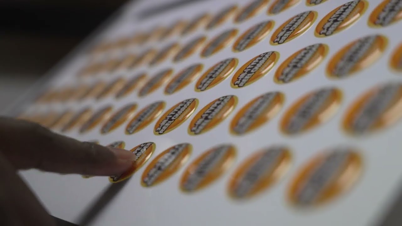 Doming on branded merchandise — full-colour label sealed under clear epoxy resin creates a glossy raised 3D effect