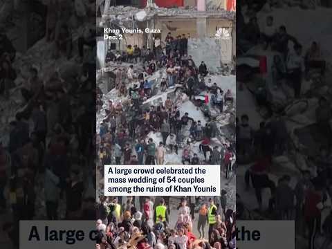 A large crowd celebrated the mass wedding of 54 couples among the ruins of Khan Younis