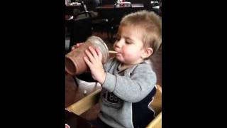 Baby drinking first milkshake